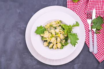 orecchiette alla pugliese, homemade Italian pasta. Orecchiette with turnip tops. Traditional food of the south of Italy, on a white background. Copy space