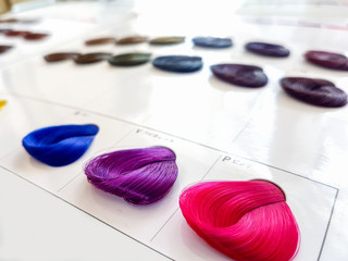 A diverse bright palette of shades of hair dyes in a beauty salon.