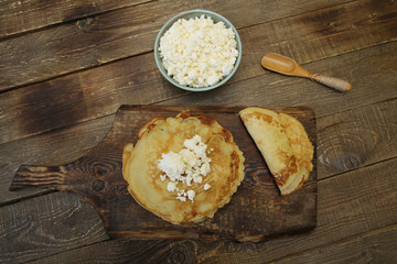 flat lay pancakes with cottage cheese on wooden rustic background