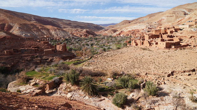 Asif Ounila Valley landscape with palm grove and fields near Berber village, High Atlas Mountains, Morocco