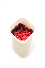 White metal container with raspberries. Fresh raspberries.