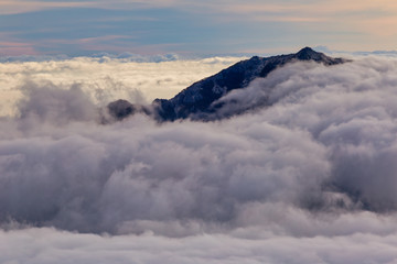 Kannongadake mountain peek above the clouds