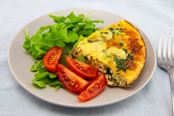 Frittata made of eggs, bacon, cheese and spinach