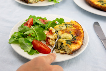 Frittata made of eggs, bacon, cheese and spinach