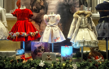  Showcase with childrens dresses, night winter look.