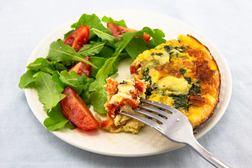 Frittata made of eggs, bacon, cheese and spinach