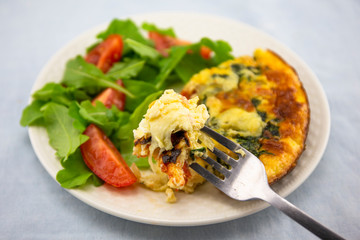 Frittata made of eggs, bacon, cheese and spinach