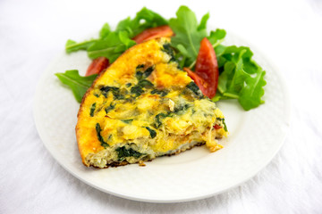 Frittata made of eggs, bacon, cheese and spinach