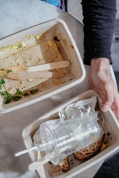 Man Hands Holding Paper Food Containers, Plastic Cup, Paper Straw, Wooden Utensils To Trash After Meal, From Above. Recycling, Waste Products, Global Enviromental Issues Concept. Take Away, To-go Food