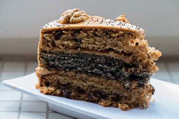 A piece of cake with condensed milk on a plate.