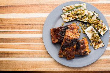 Pork BBQ Ribs. Tradtional Classic barbecue staple. Pork ribs seasoned with a dry rub and slow cooked in a smoker over mesquite wood chips and covered in bbq sauce. 