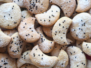 Homemade shortbread cookies sprinkled with sugar with black sesame seeds on a wooden rustic table. Place for text. Photo for the holiday, Shrovetide, Christmas, New Year, Easter.
