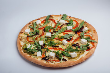 Pizza with feta arugula pepper and leafy tomatoes. Vegetarian pizza. Vegan pizza