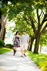 Fototapeta na wymiar Happy Young Couple Walking on Sidewalk in Neighborhood