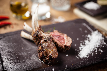 Grilled lamb chops served with a branch of rosemary