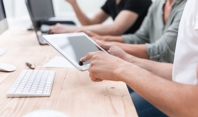 close up. the employee uses a digital tablet in the workplac