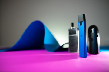 many Electric cigarette pod In the abstract pink and blue background .