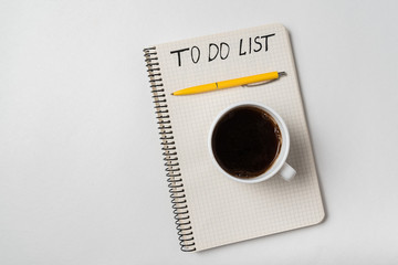 Handwritten notice in notepad To do List. Morning planning concept. White background