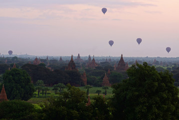 Air ballons flying over Bagan temples and pagodas in early morning before sunrise, Burma Myanmar