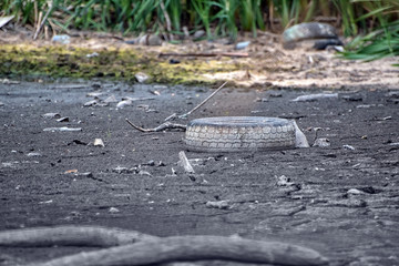 Old tire pollution. Problems of waste disposal. Protection of the environment. Ecology concept