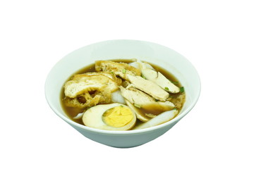 Chinese rice flour paste with slice chicken and fried tofu topping egg in brown soup