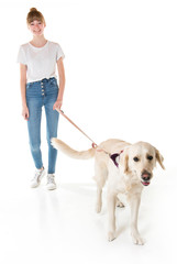 Nice teen woman and her beautiful Golden Retriever dog over white background