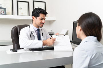 Woman Visiting Doctor In Clinic