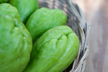 Fototapeta premium Green fresh chayote in bamboo basket.