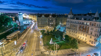 Sitkovska water-tower night timelapse circa 1588 and traffic on road in old city center of Prague.