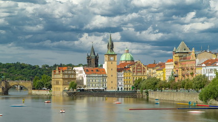 Fototapeta na wymiar Charles Bridge and historical buildings timelapse in Prague from across the river. Staromestsky water tower. Prague, Czech Republic.