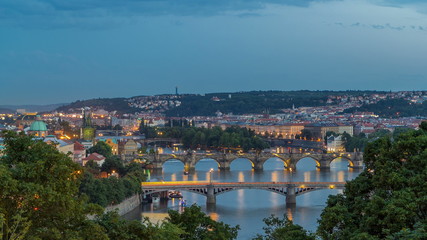 Fototapeta na wymiar Scenic view of bridges on the Vltava river day to night timelapse and of the historical center of Prague: buildings