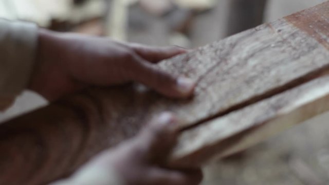 Carpenters cut wood in a sawmill, extreme close up, shallow DOF