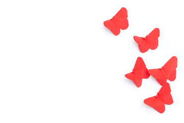 Red origami paper butterflies on white background.