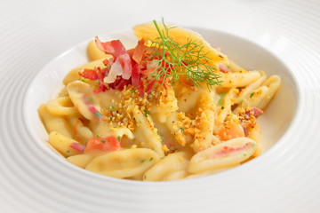 Cavatelli pasta with beans cream, red onion, crispy bacon and fried bread crumbs, Apulia, Italy