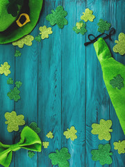 St Patrick Day dark green wooden rustic background with shamrocks and leprechaun costume accessories - 326409550