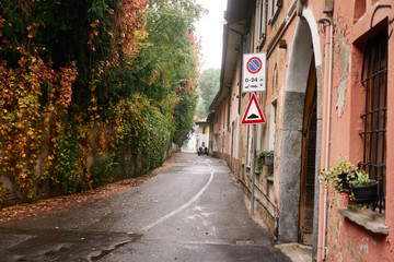 Exterior of historical buildings on the narrow street close to park in the european architectural city center