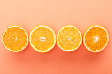 Top view of cut citrus fruits on orange background