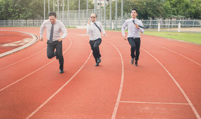 Successful young businessman winning the race. Businessman crossing the finish line. Concept of successful businessman in a finishing line.