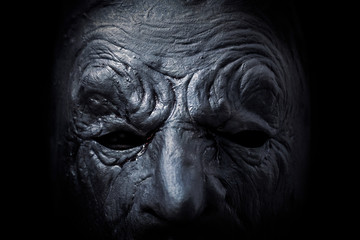 Fototapeta na wymiar Scary figure with mask in the dark, macro shot