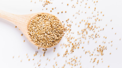 Food swap. White quinoa in round wooden spoon