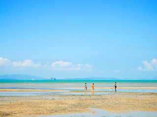 Fototapeta na wymiar Children are playing in the sea on blue sky day , Koh yao , Thailand