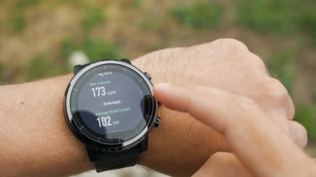 Results of a running training session on smart watch. Smartwatch. Hand with sports watch which shows results of training. Pulse, speed, distance, calories
