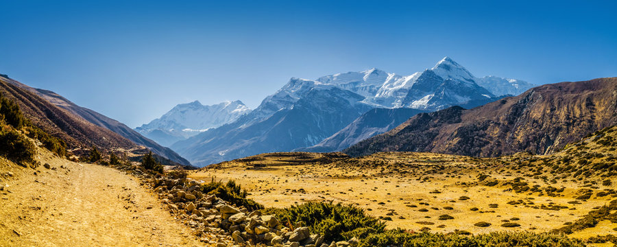Kone Khola valley with Mt. Gangapurna on the horizon. Trekking route from Manang to Ledar village in autumn sunny day. Annapurna circuit trek, Nepal.