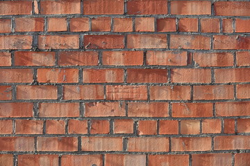 Obraz premium Old shabby, wrecked brick wall with grey cement mortar as background
