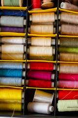 set of multi-colored skeins of thread for sewing in a case