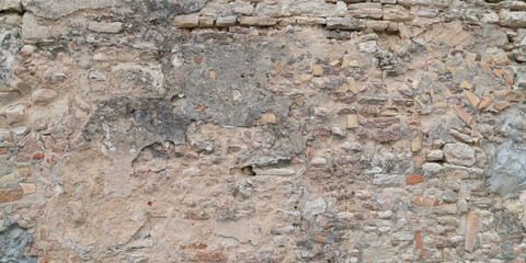 Old stone damaged ancient brick wall texture background