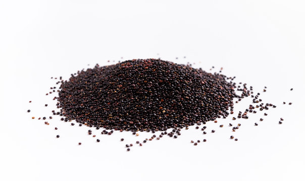 Scattered raw Black quinoa on white background