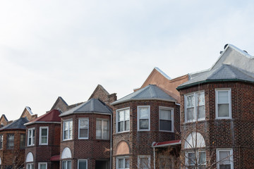Fototapeta na wymiar Row of Similar Old Brick Homes in Astoria Queens New York