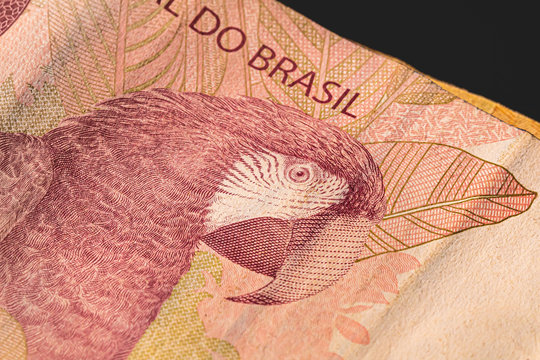 Brazilian currency. 10 reais banknote on a table, black background.