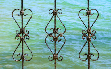 Art work old iron, gate, frame, decorative wrought fence retro decor architecture, element, ornament.